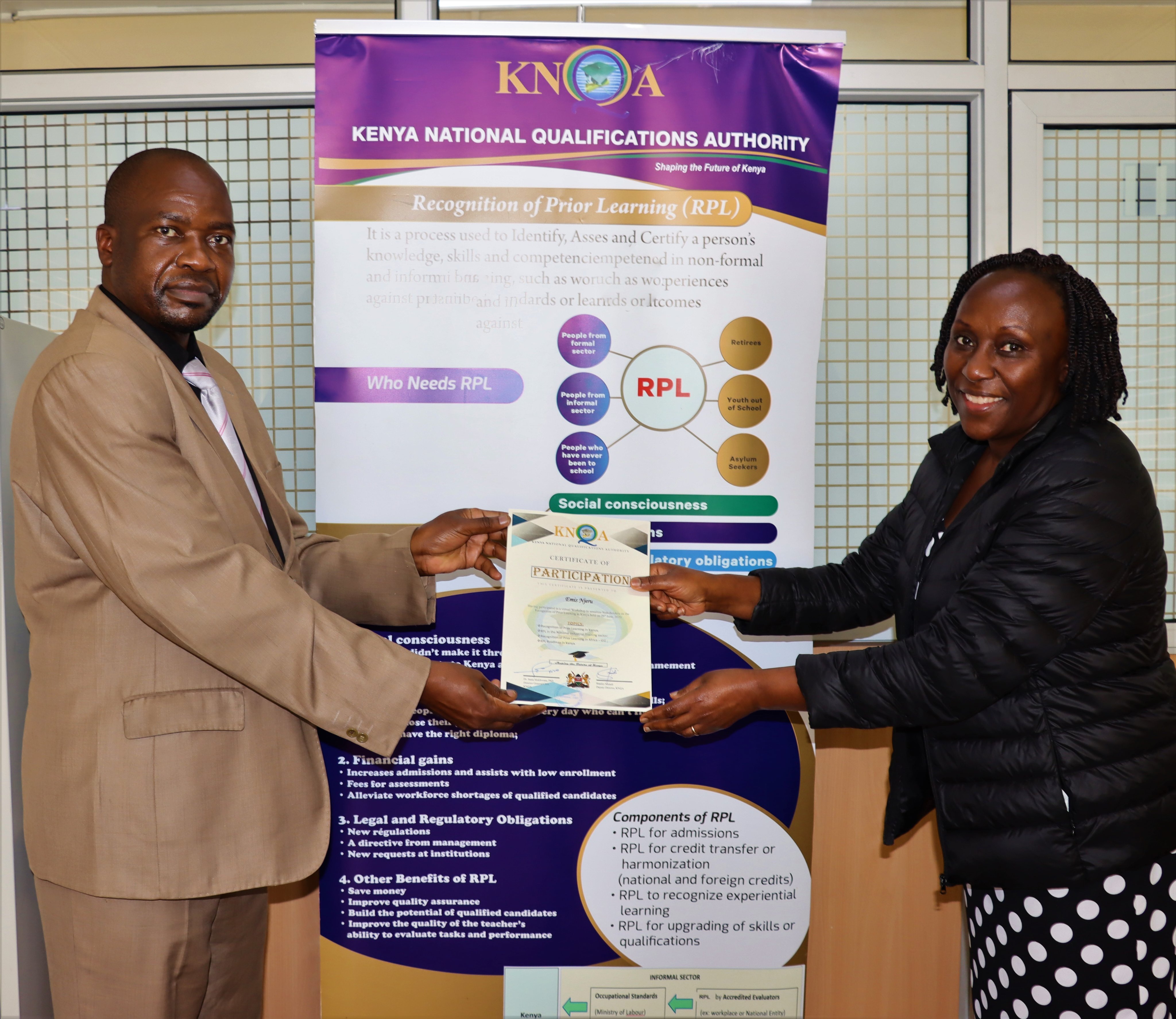 Deputy CEO, National Council for Nomadic Education in Kenya (NACONEK), Emis Njeru receives a certificate of Participation in KNQA’s Validation Workshop from S. Maindi  of KNQA