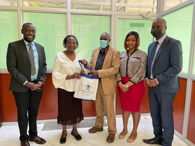 RAD HoD Mr. James Tegeret hands a gift hamper to Ms. Phoebe Gachau a representative of the International Certificate of Christian Education Limited in Kenya (ICCE Ltd) after a consultative meeting.