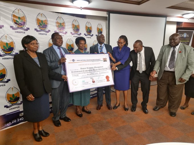 The acting chair KNQA CPA Rosemary Njogu accompanied by the DG  KNQA handing over an accreditation certificate to the Human Resources Management Professionals Examination Board (HRMPEB). Chair appreciate HRMPEB has transformed all its Qualifications to make them competence based.